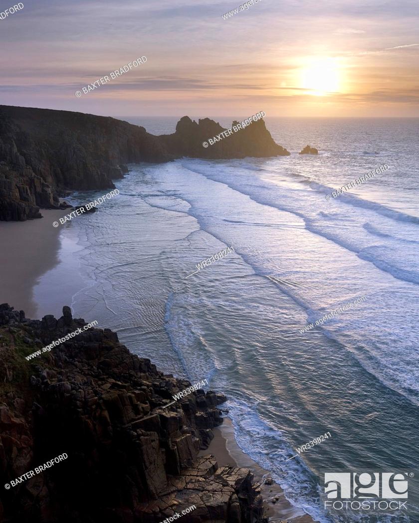 Stock Photo: Sunrise over the beautiful and secluded beach at Pedn Vounder overlooking Logan Rock, near Porthcurno, Cornwall, England, United Kingdom, Europe.