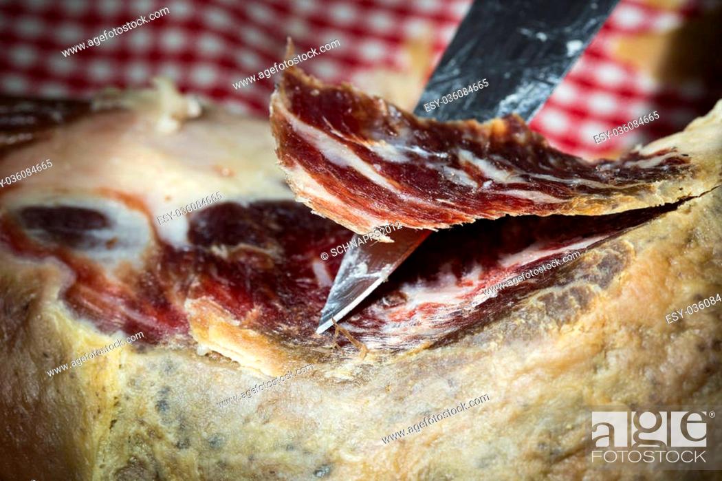 Stock Photo: A pata negra spanish dried ham on a dark background.