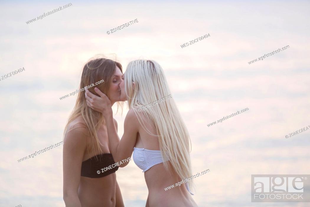 Young women kissing