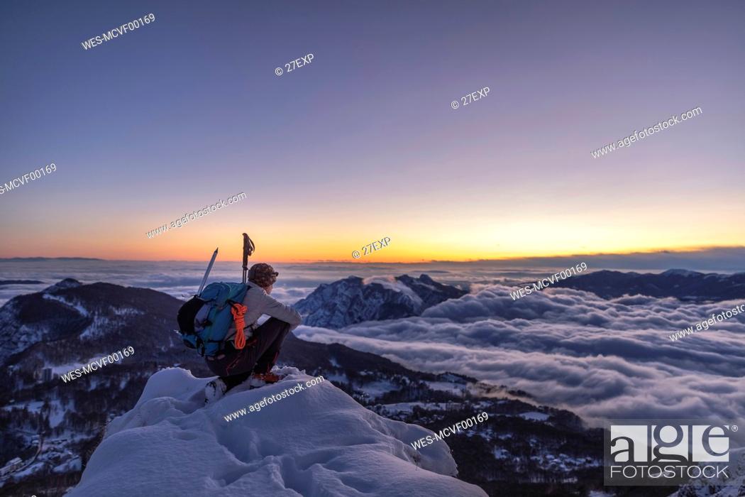 Stock Photo: Mountaineer on the mountain summit during twilight, Orobie Alps, Lecco, Italy.