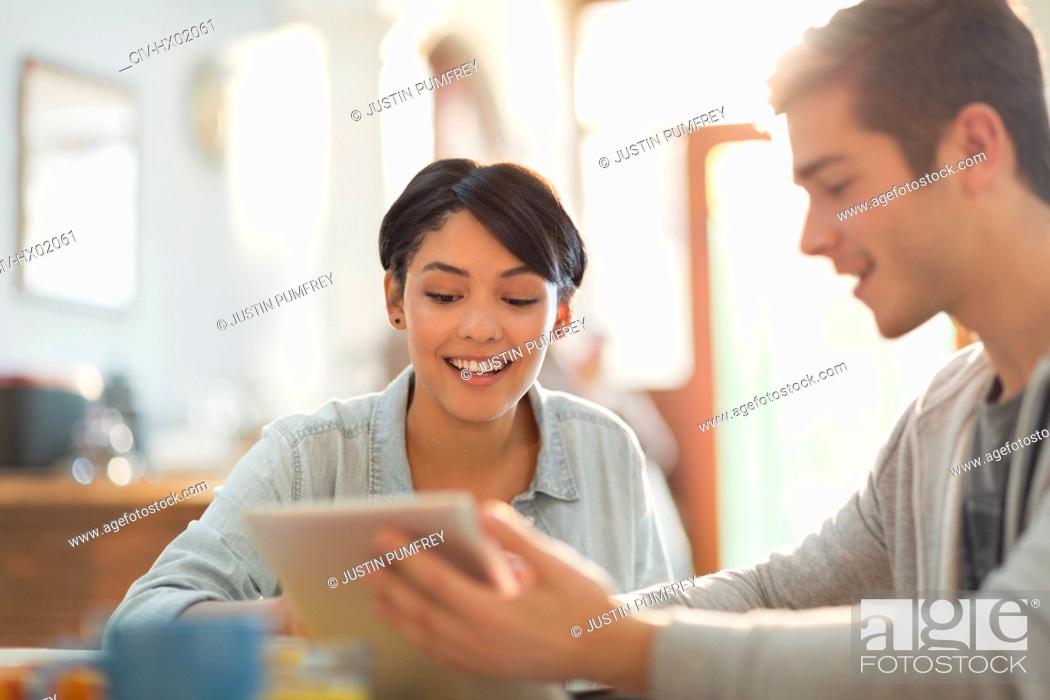 Stock Photo: Young couple using digital tablet.