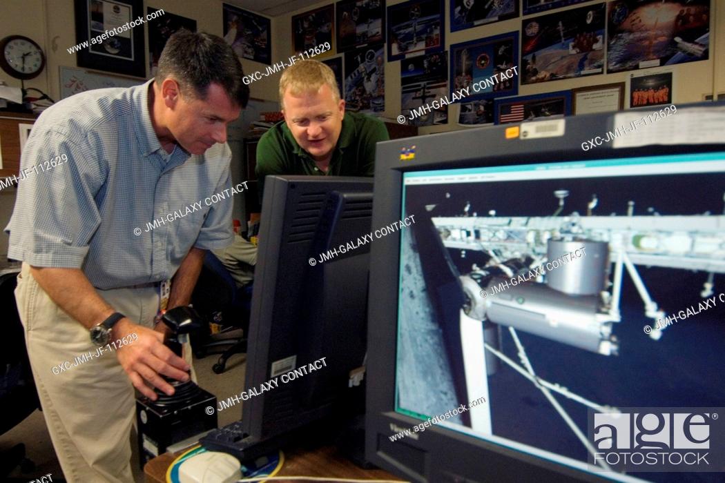 Stock Photo: Astronauts Robert S. (Shane) Kimbrough (left), STS-126 mission specialist; and Eric A. Boe, pilot, use the virtual reality lab in the Space Vehicle Mockup.