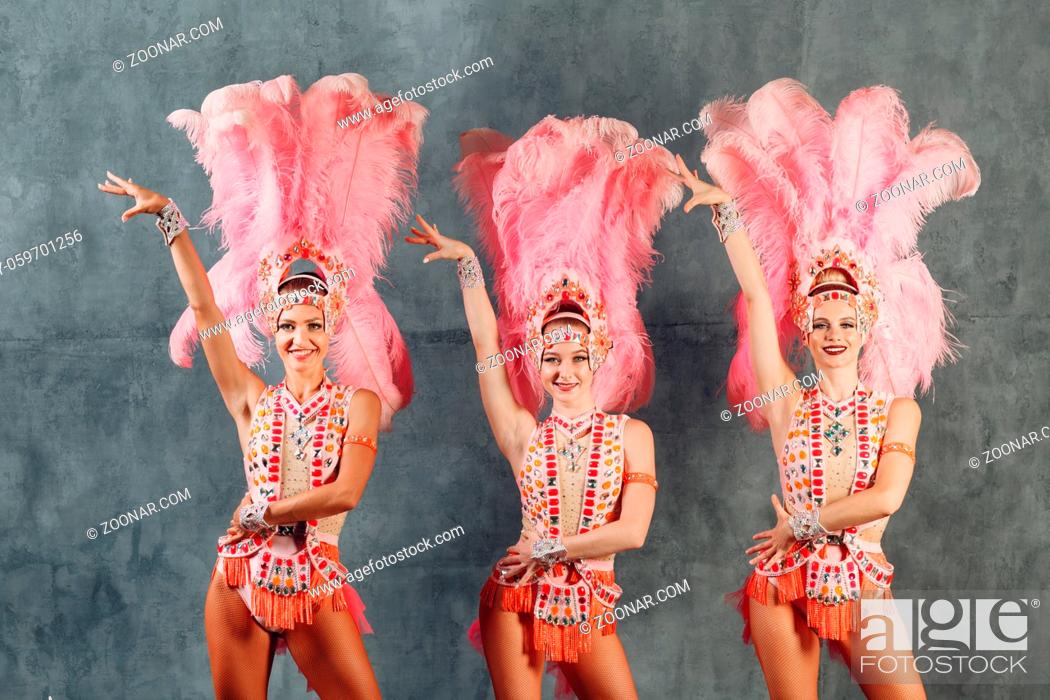 Stock Photo: Three Women in samba or lambada costume with pink feathers plumage.