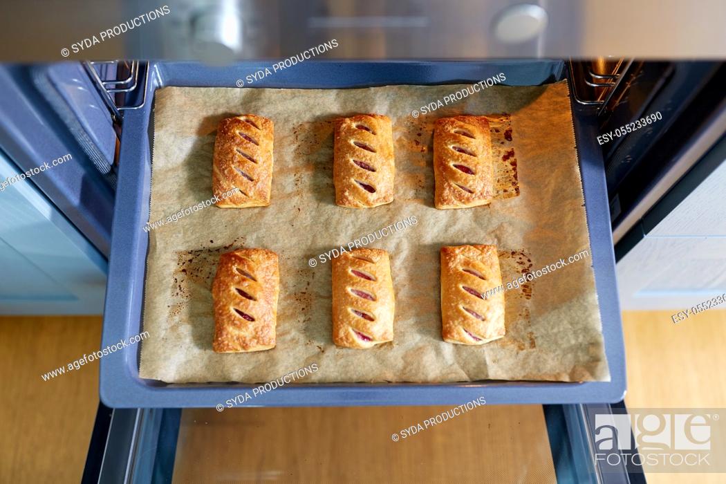 Stock Photo: baking tray with jam pies in oven at home kitchen.