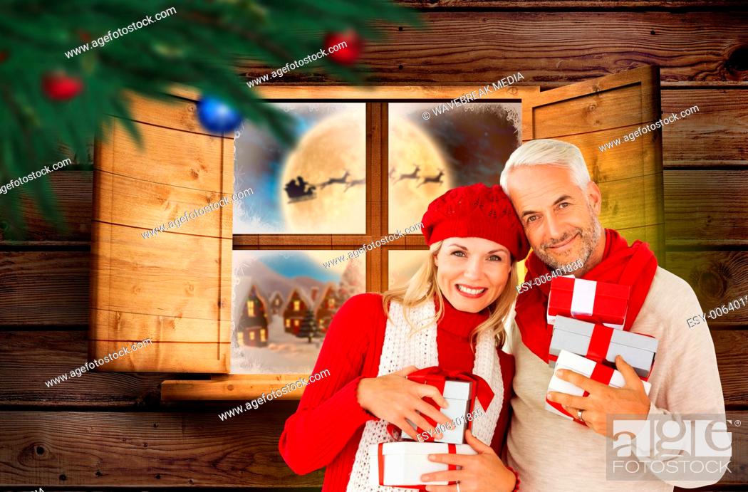 Stock Photo: Composite image of happy festive couple with gifts.