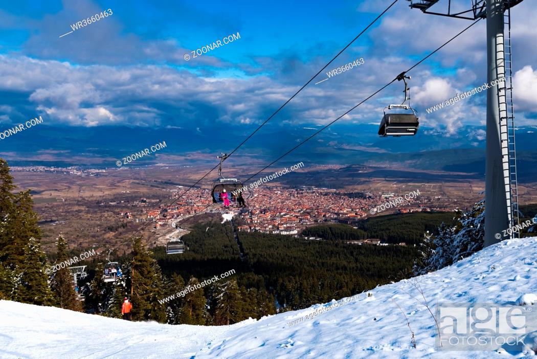 Stock Photo: Bulgaria. Bansko. 10 February 2020.Ski resort in Bansko. Snowy ski slopes and chair ski lifts station in winter mountain ski resort.