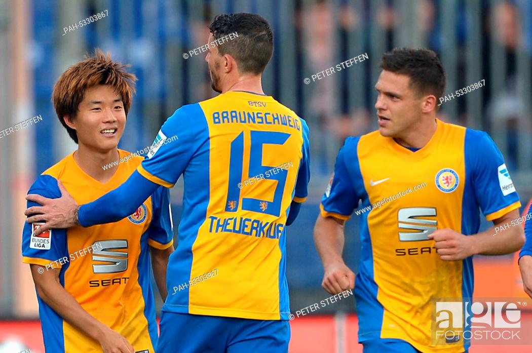Stock Photo: Braunschweig's Seung-Woo Ryu (L) celebrates his 1-0 goal with his teammates Norman Theuerkauf and Mirko Boland (R) during the German 2nd Bundesliga soccer match.