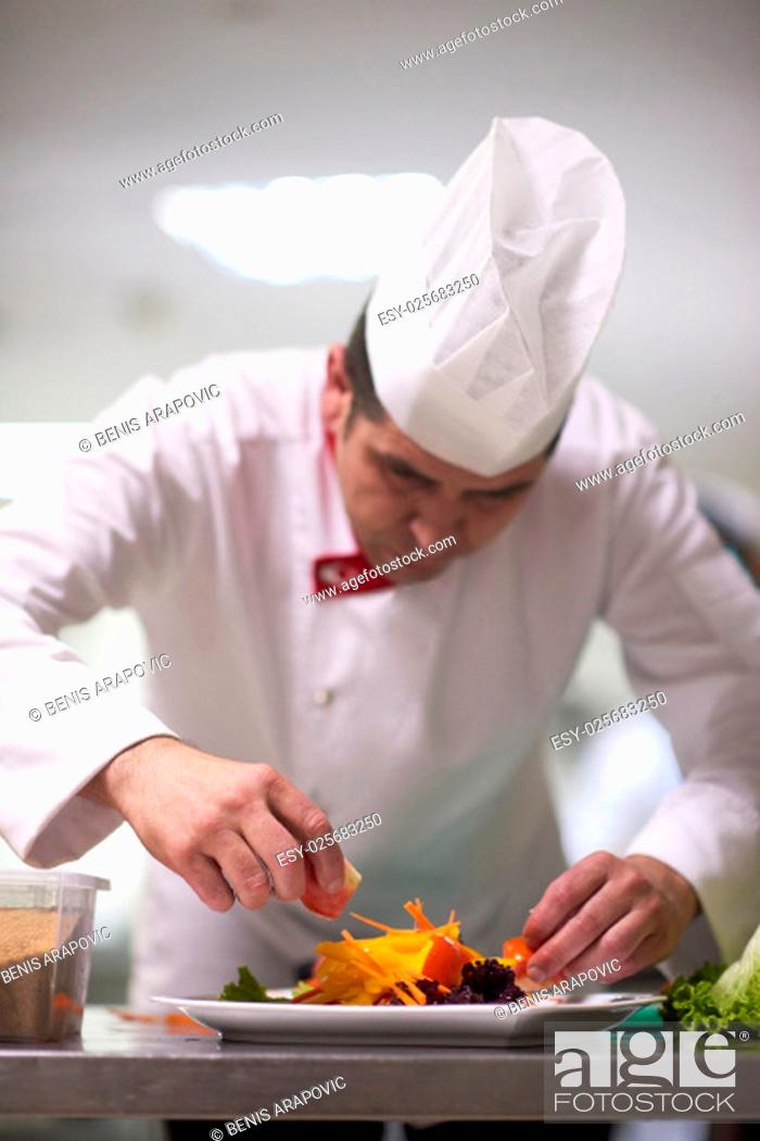 Stock Photo: chef in hotel kitchen preparing and decorating food, delicious vegetables and meat meal dinner.