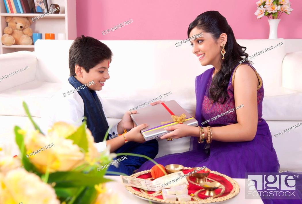 Sister giving brother gift