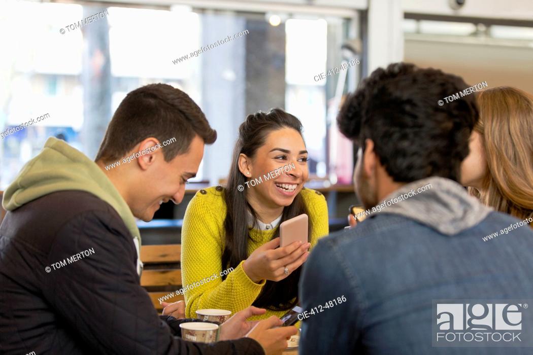 Stock Photo: Happy young adult friends in cafe.