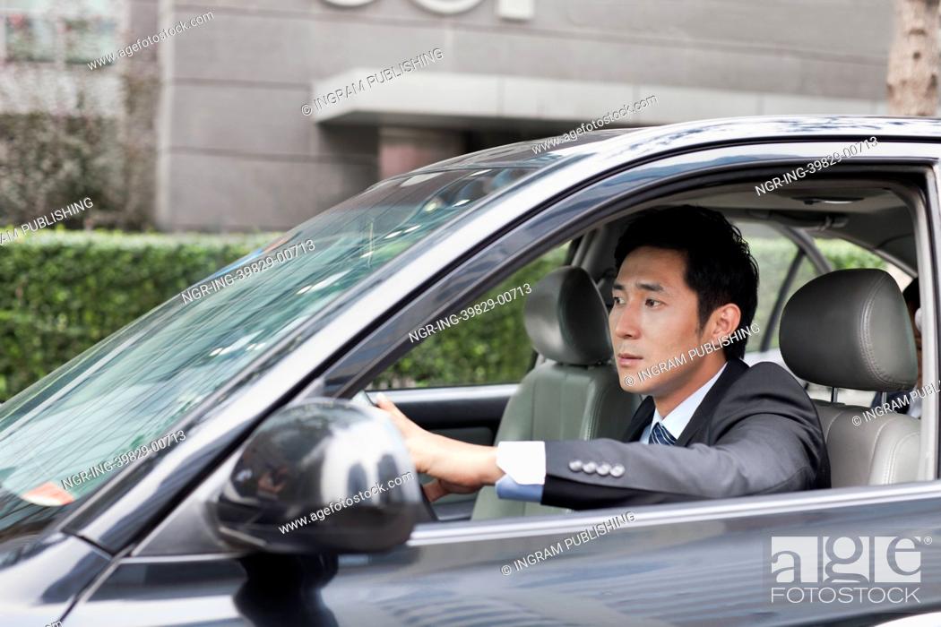 Stock Photo: Businessman Driving Car.