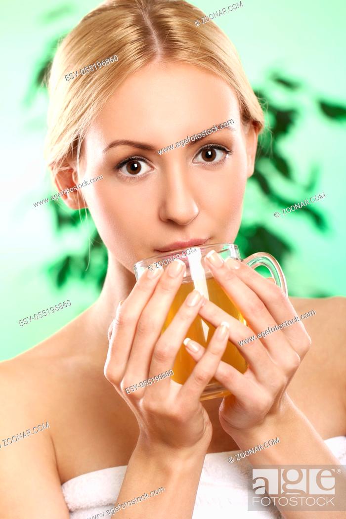 Stock Photo: Beautifu and youngl blonde with cup of green hot tea.