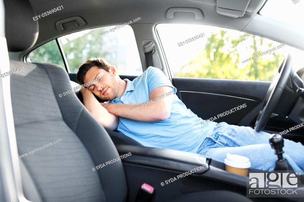 Stock Photo: tired man or driver sleeping in car.