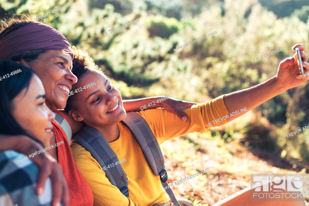 Stock Photo: Happy mother and daughter hikers taking selfie with camera phone.