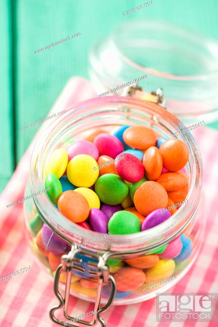 Stock Photo: Colorful chocolate candy pills in jar.