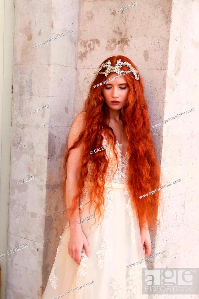 Beautiful red-haired girl with long curly hair in the bride, in a long lace  dress, Stock Photo, Picture And Low Budget Royalty Free Image. Pic.  ESY-041235535 | agefotostock