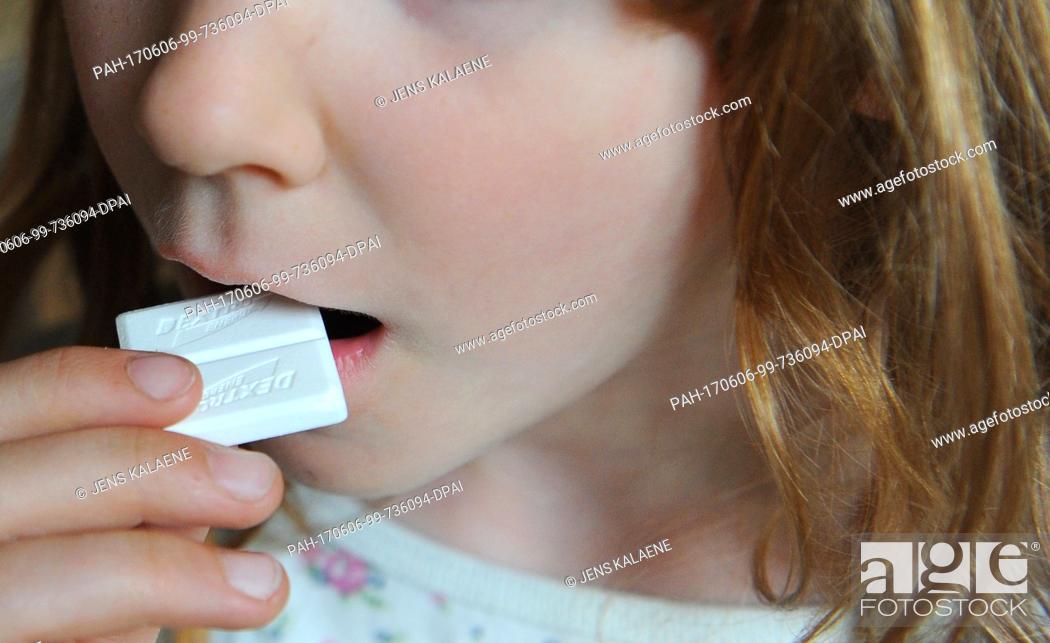 Stock Photo: FILEÂ - A file picture dated 26 April 2011 shows a girl bringing a piece of Dextro Energy to her mouth, in Berlin, Germany.