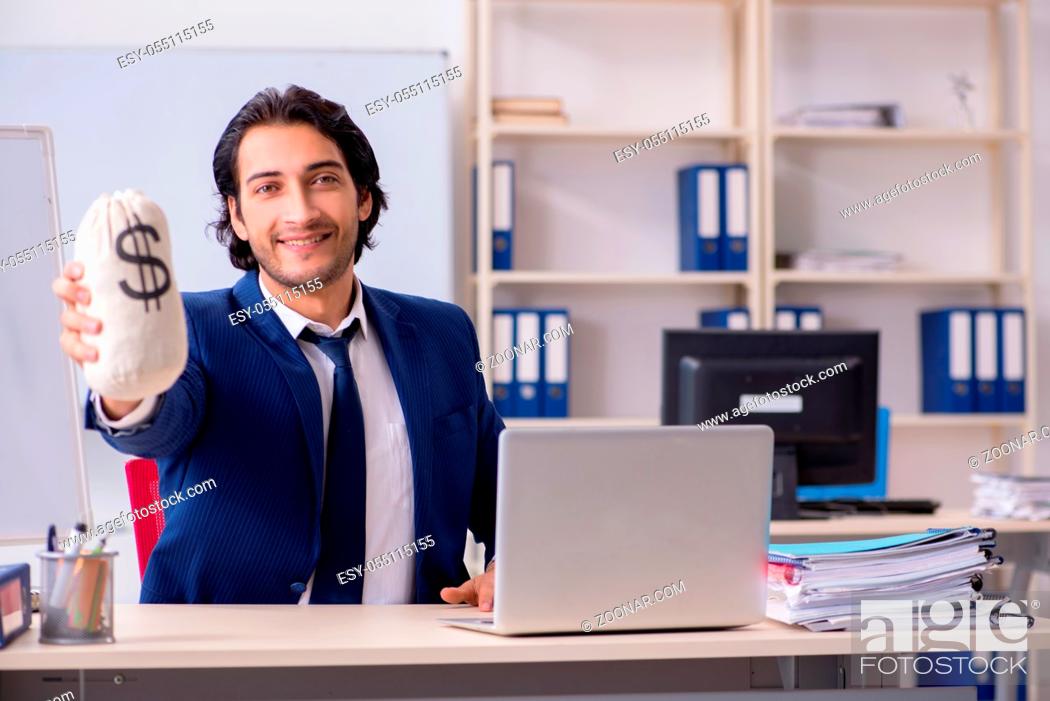 Stock Photo: Young handsome businessman working in the office.
