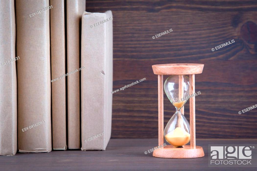Photo de stock: Sandglass, hourglass or egg timer on wooden table showing the last second or last minute or time out.
