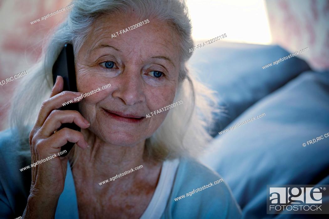 Stock Photo: Senior woman talking on smart phone.