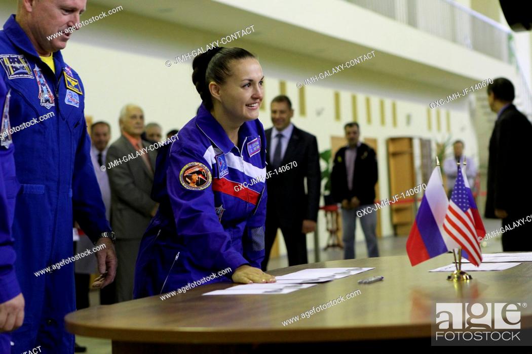 Stock Photo: At the Gagarin Cosmonaut Training Center in Star City, Russia, Expedition 4142 Flight Engineer Elena Serova of the Russian Federal Space Agency (right) flashes.