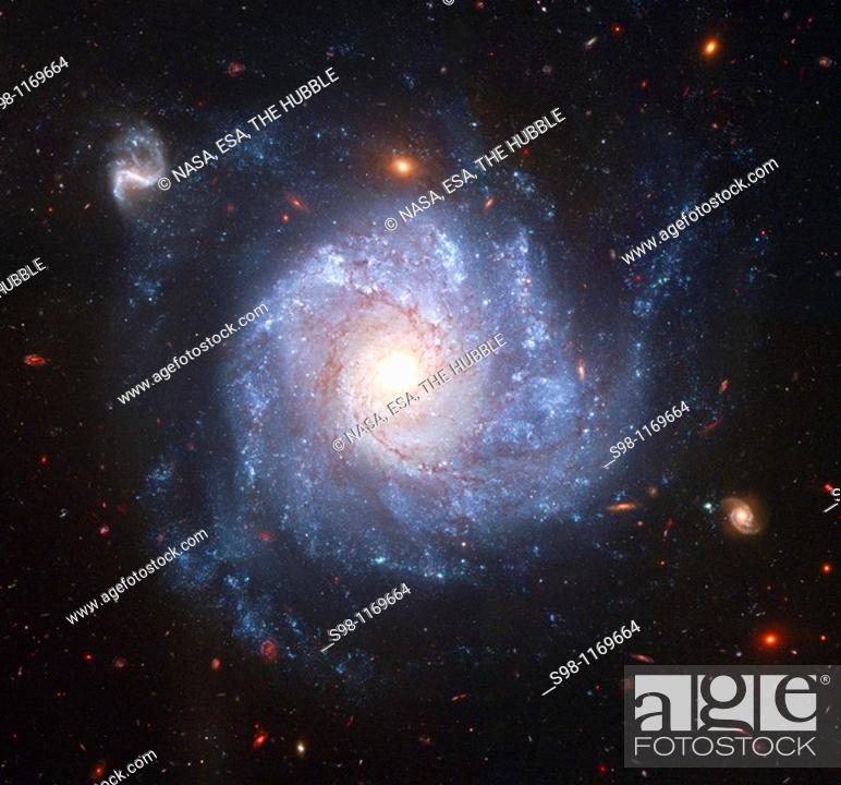 Stock Photo: Looking like a child's pinwheel ready to be set a spinning by a gentle breeze, this dramatic spiral galaxy is one of the latest viewed by NASA's Hubble Space.