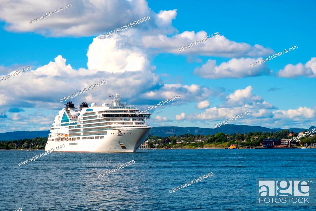 Stock Photo: Oslo, Ostlandet / Norway - 2019/09/02: Panoramic view of Oslofjord harbor from Hovedoya island with MV Seabourn Ovation cruise ship by Seabourn Cruise Line in.