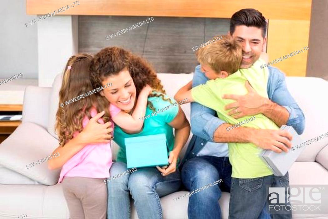 Stock Photo: Young siblings giving presents to their parents.