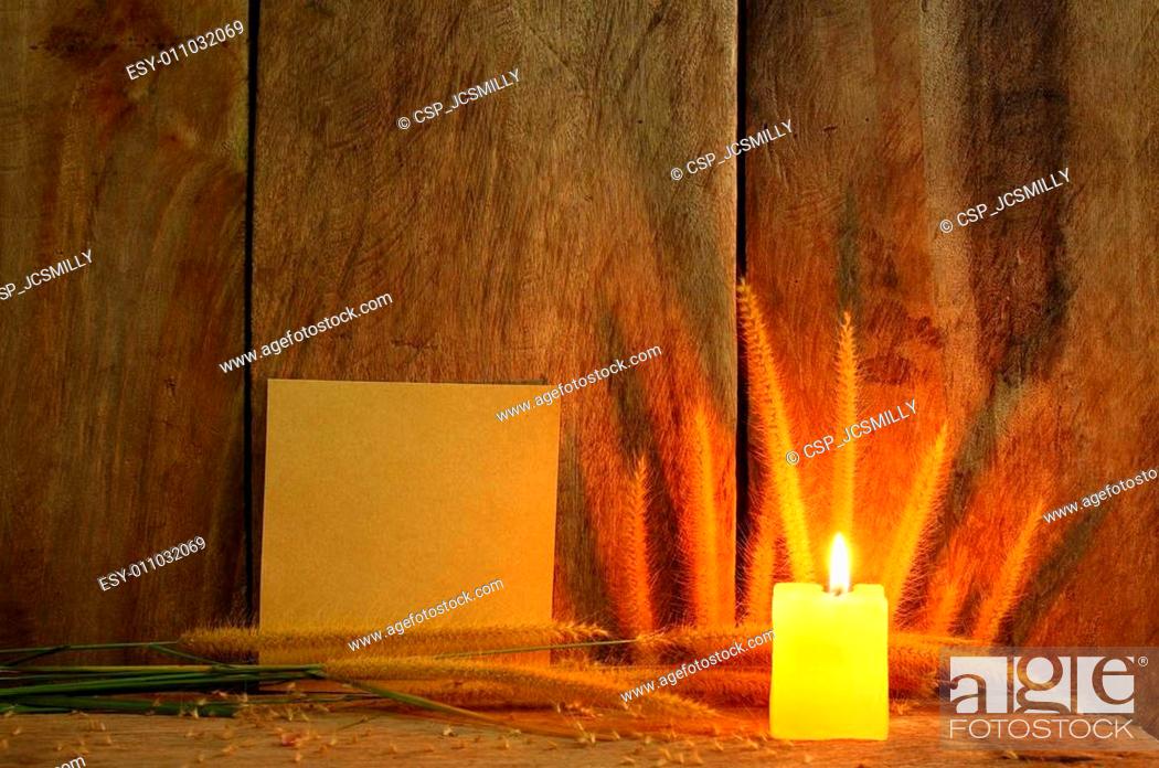 Stock Photo: Still life with Foxtail grass, burning light and notepad on wooden background.