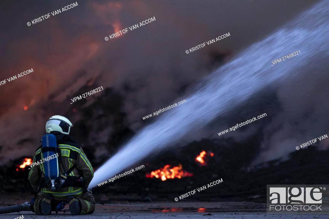 Stock Photo: A fire fighter pictured at the site of IOK recycling and waste management company, in Beerse, Monday 28 March 2022. BELGA PHOTO KRISTOF VAN ACCOM.