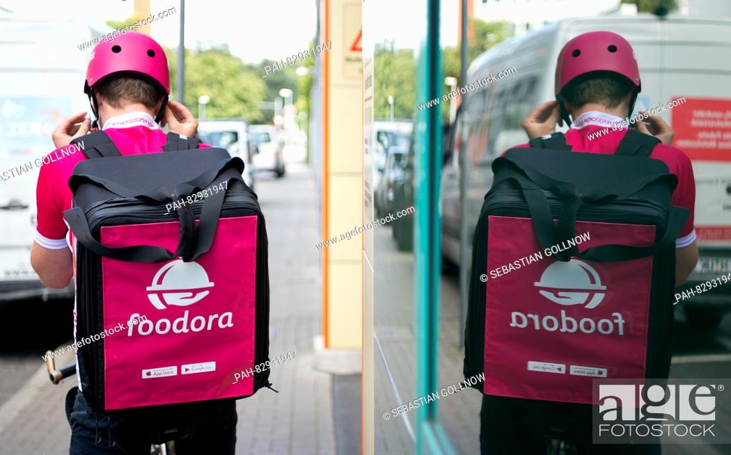 Stock Photo: Bike courier Anton from Foodora puts on his helmet in Hanover, Germany, 18 August 2016. .PHOTO: SEBASTIAN GOLLNOW/DPA | usage worldwide.