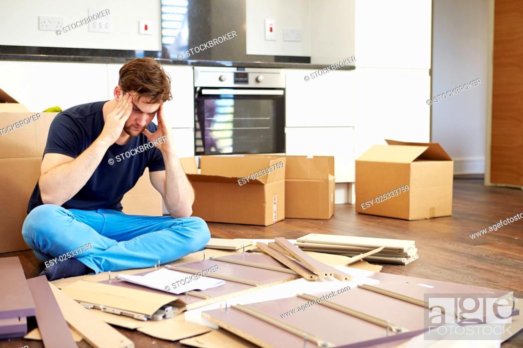 Stock Photo: Frustrated Man Putting Together Self Assembly Furniture.