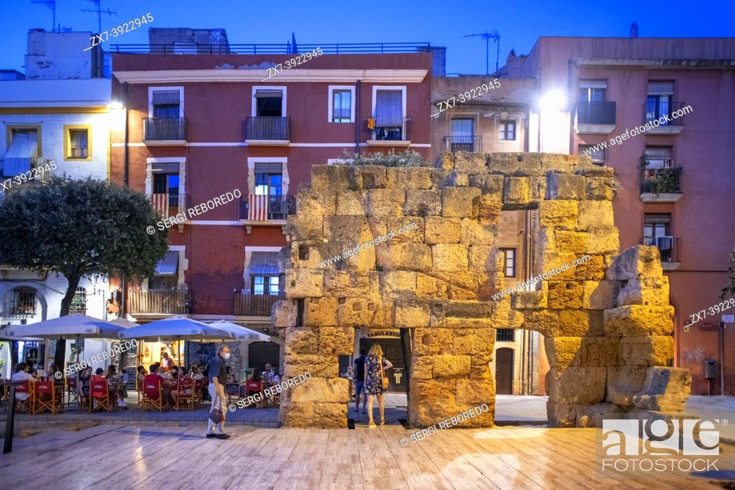 Stock Photo: Roman ruins facades of houses buildings and restaurants in Plaça del Forum Square in the old city center of Tarragona. Tarragona old town and city center.