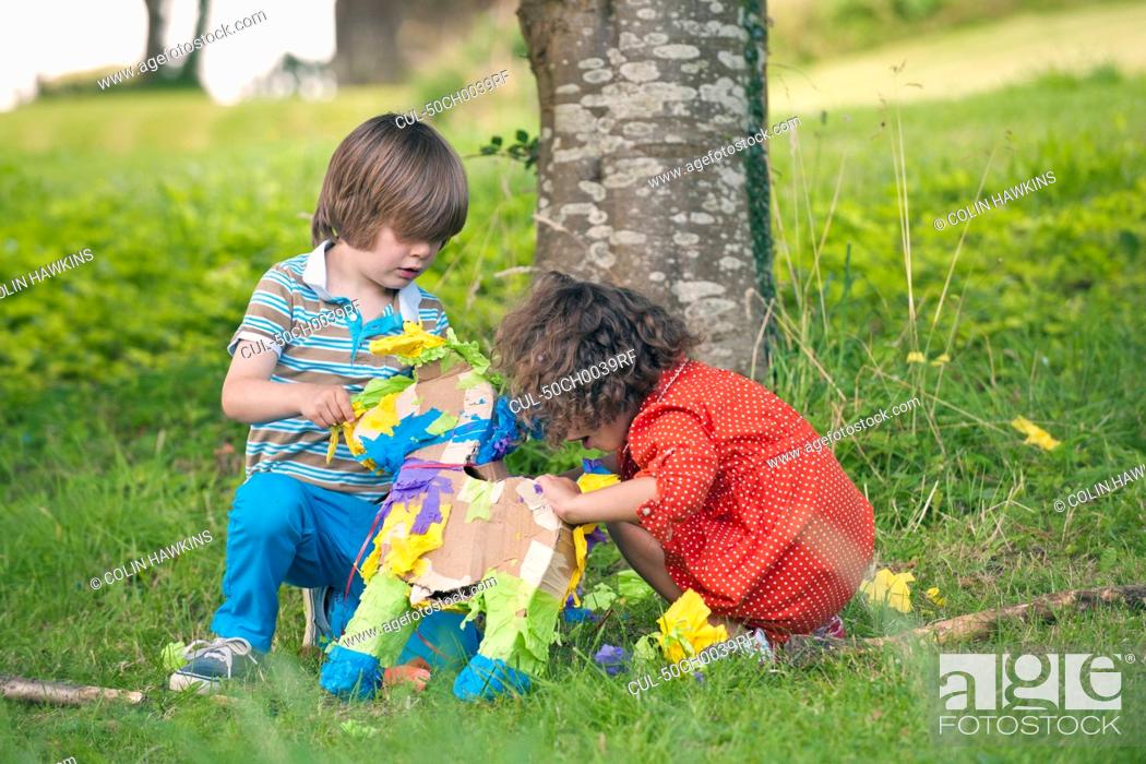 Stock Photo: Children opening pinata at party.