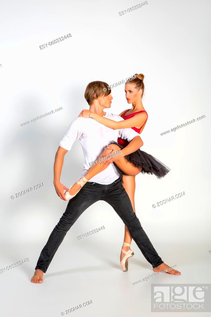 Stock Photo: beautiful ballet couple. ballerina in black tutu skirt. man in jeans and white shirt. studio shot. copy space.
