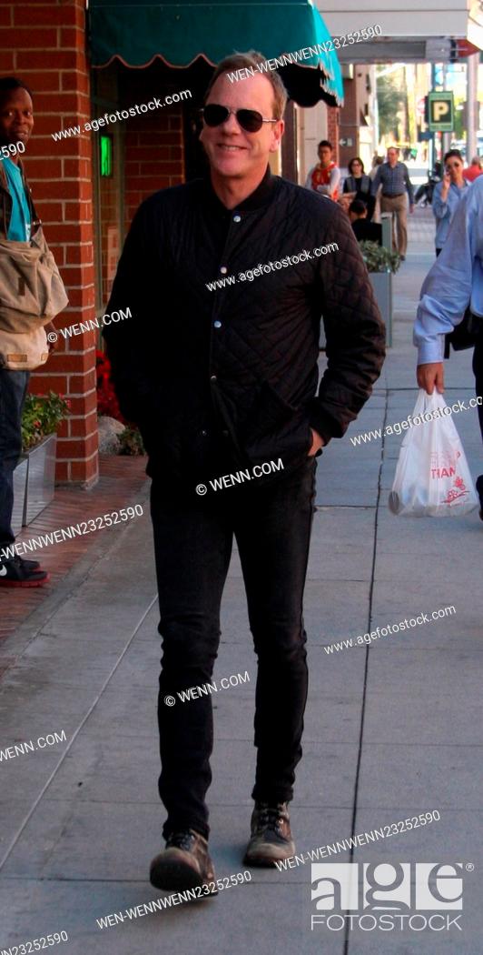 Stock Photo: Kiefer Sutherland dressed all in black in skinny jeans and old scruffy boots out running errands in Beverly Hills wearing aviator sunglasses Featuring: Kiefer.