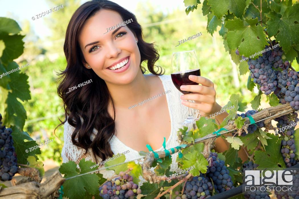 Stock Photo: Pretty Mixed Race Young Adult Woman Enjoying A Glass of Wine in the Vineyard.