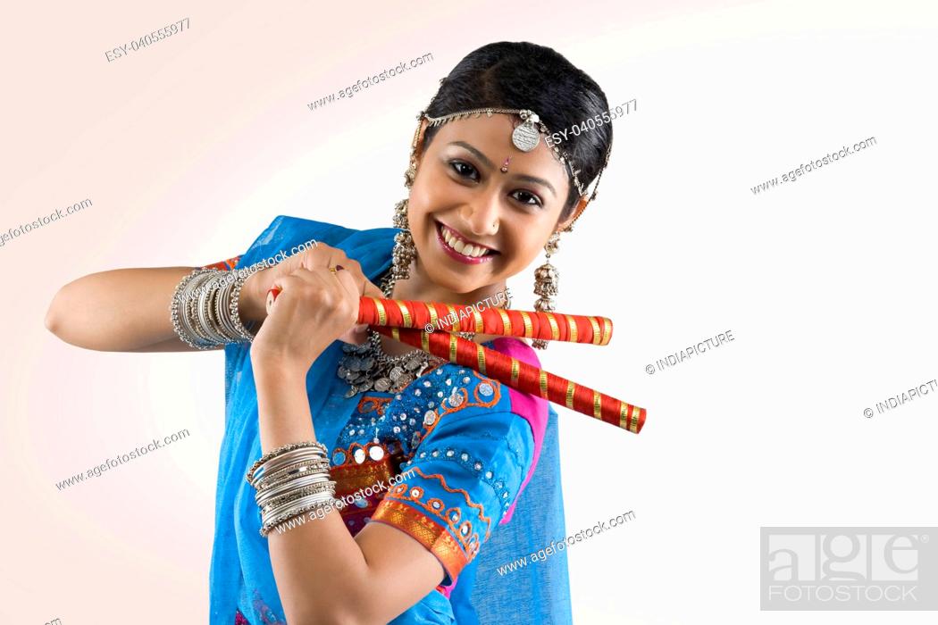 Young woman in chaniya choli performing Dandiya Raas over white background  Stock Photo - Alamy