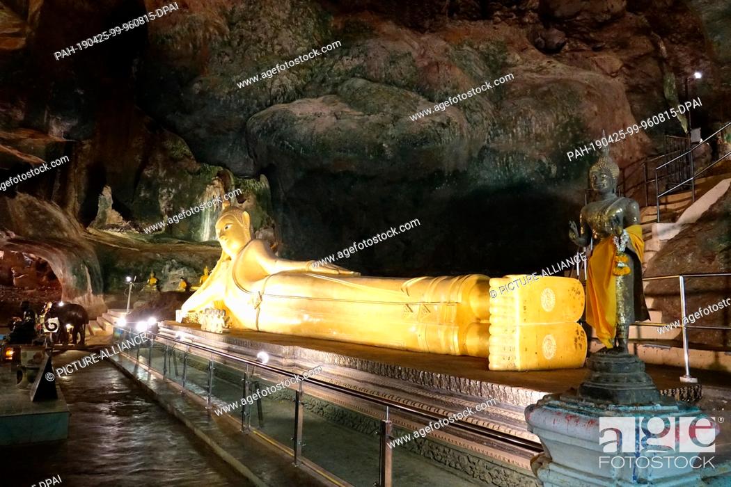 Stock Photo: 04 March 2019, Thailand, Takua Thung: A Buddha statue in the largest cave (""Tham Yai"") of Wat Suwan Kuha, also called Wat Tham (""cave temple"").