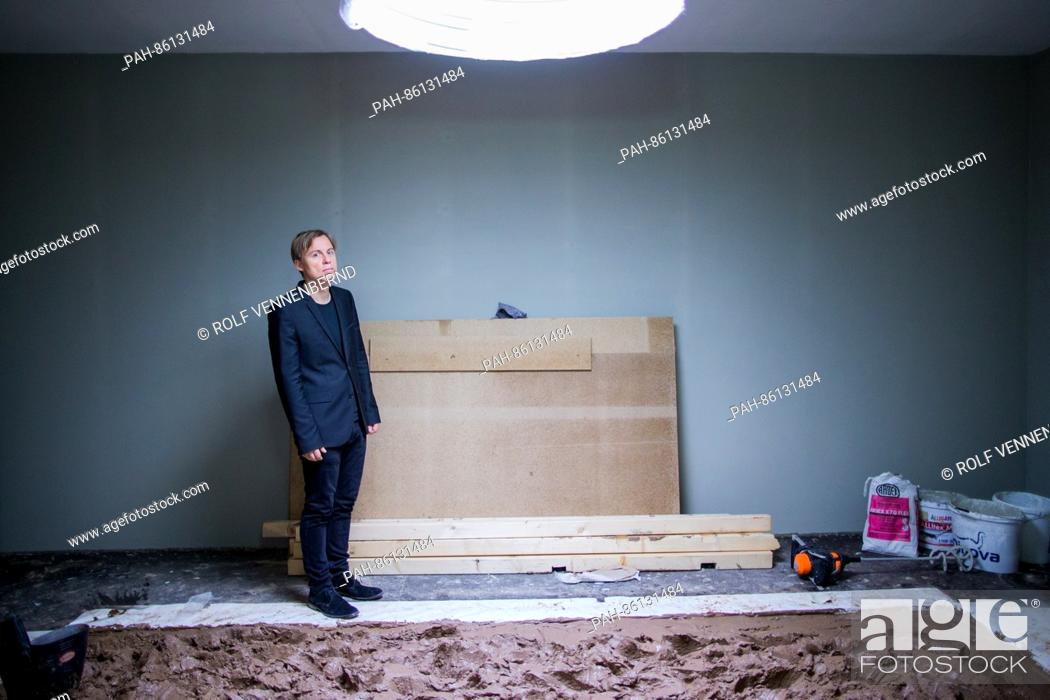 Stock Photo: The artist Gregor Schneider stands in the Federal Art Hall in the room ""Matschraum"" (lit. ""mud room"") in Bonn, Germany, 30 November 2016.