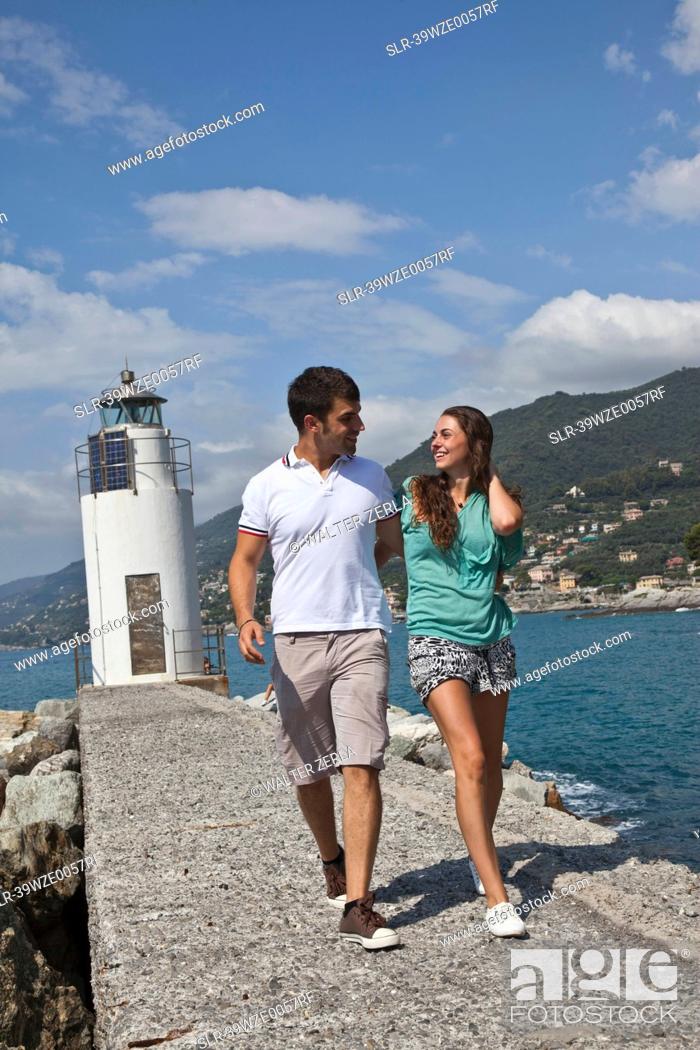 Stock Photo: Couple walking by lighthouse.