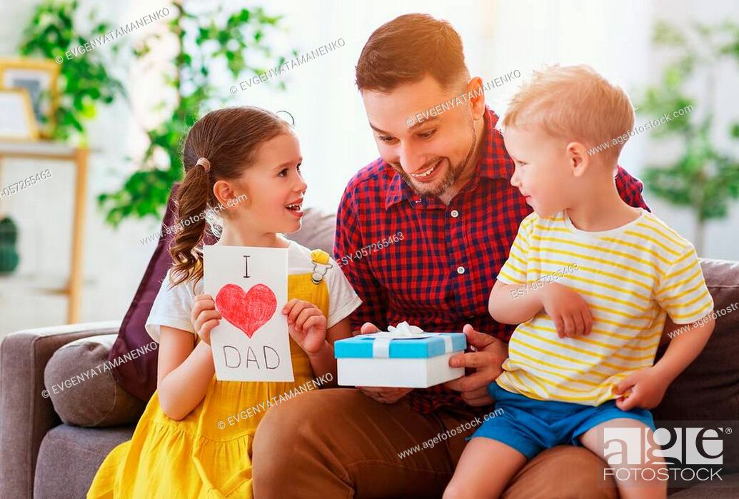 Stock Photo: Happy father's day! Children congratulates dad and gives him a gift and postcard.