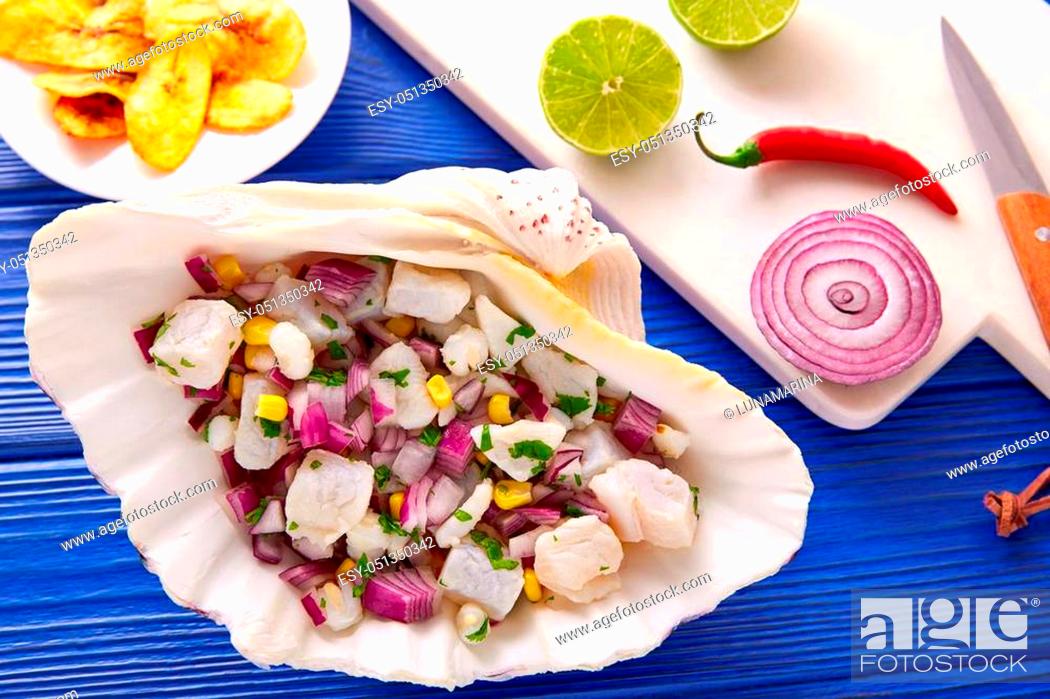 Stock Photo: Ceviche peruvian recipe with fried banana and ingredients on wooden blue table.