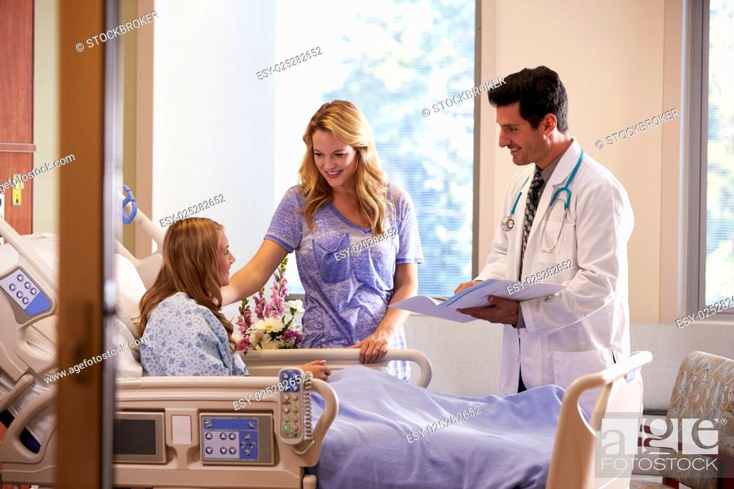 Stock Photo: Doctor Talks To Mother With Teenage Daughter In Hospital.