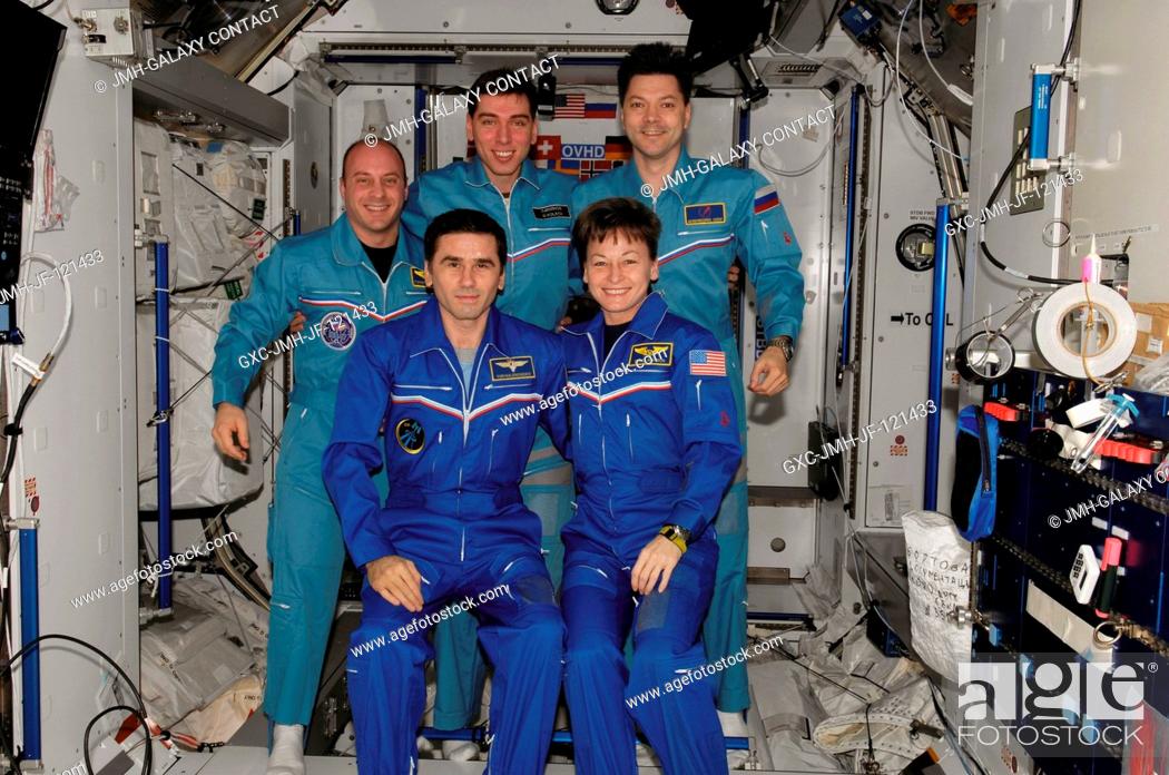Stock Photo: The crewmembers onboard the International Space Station pose for a group portrait during the ceremony of Changing-of-Command from Expedition 16 to Expedition 17.