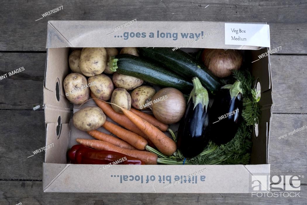 Stock Photo: High angle close up of an organic vegetable box with a selection of fresh produce.