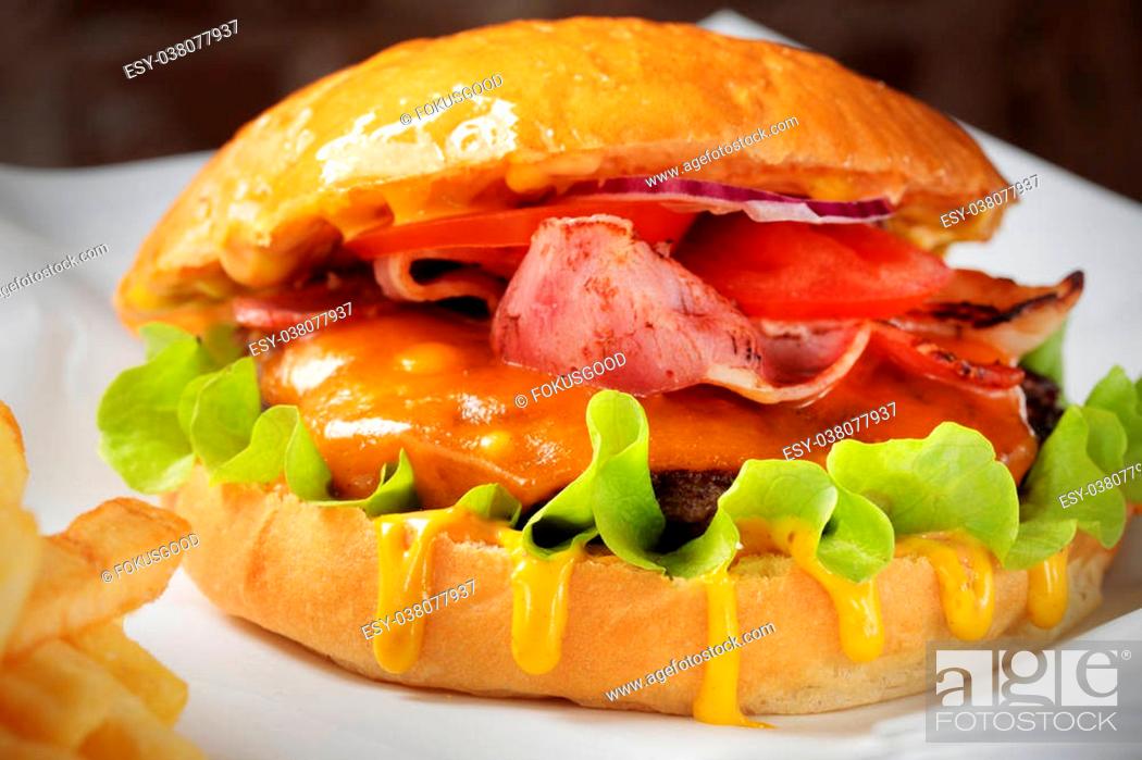 Stock Photo: close-up of a burger on paper.