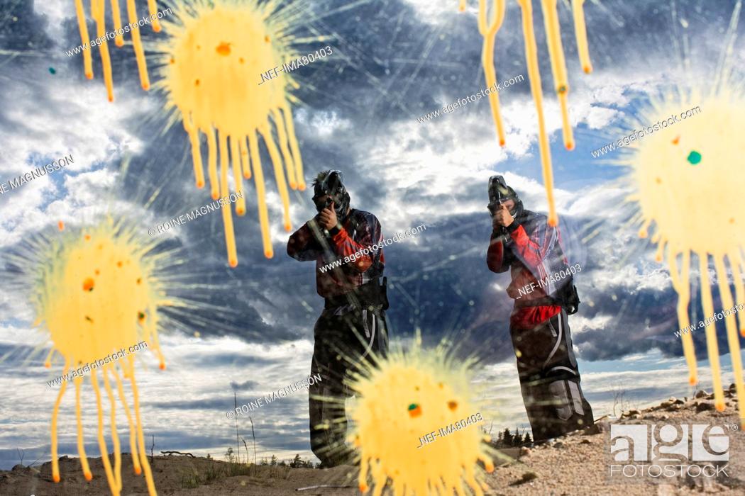 Stock Photo: Men playing paintball, Sweden.
