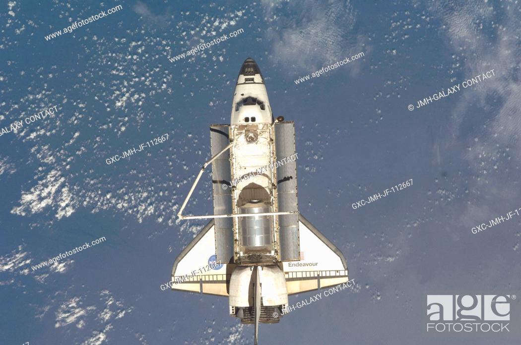 Stock Photo: Backdropped by a blue and white Earth, Space Shuttle Endeavour is featured in this image photographed by an Expedition 18 crewmember after the shuttle undocked.