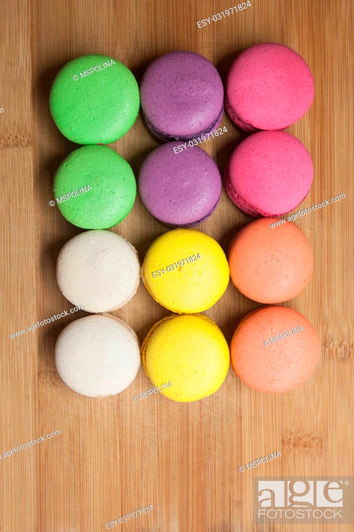 Stock Photo: macaroons on the wooden coffee desk in vintage color tone.
